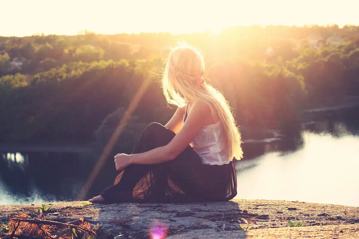 Woman looking out over a vista at sunrise